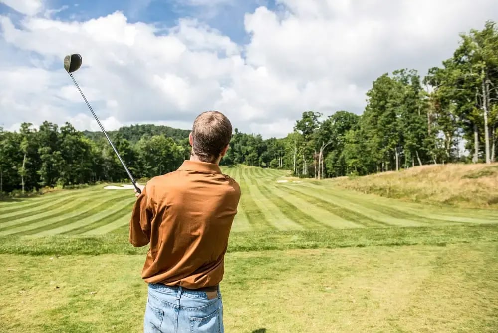 man swinging a golf club